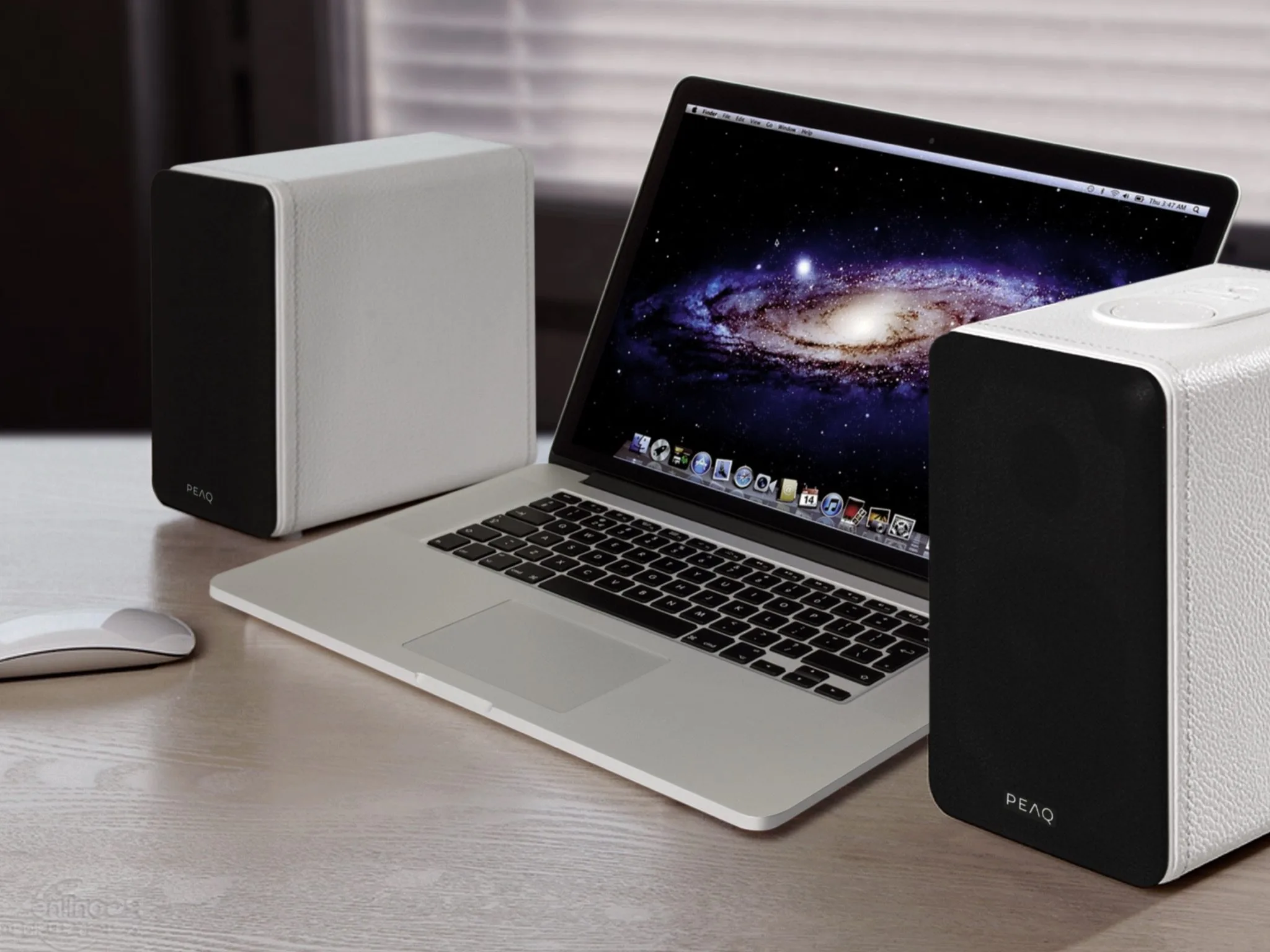 Yuppies in PEAQ white leather beside a MacBook